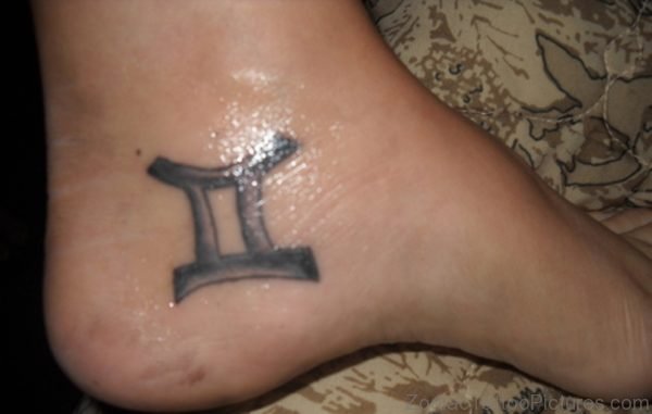 Grey Colored Gemini Tattoo On Ankle