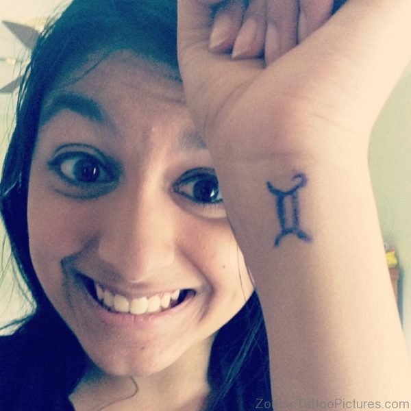 Women Showing Her Gemini Tattoo On Wrist