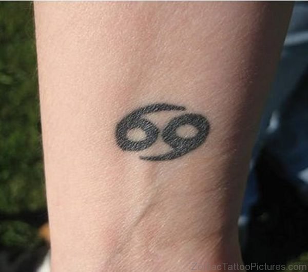 Black Ink Cancer Zodiac Tattoo On Wrist