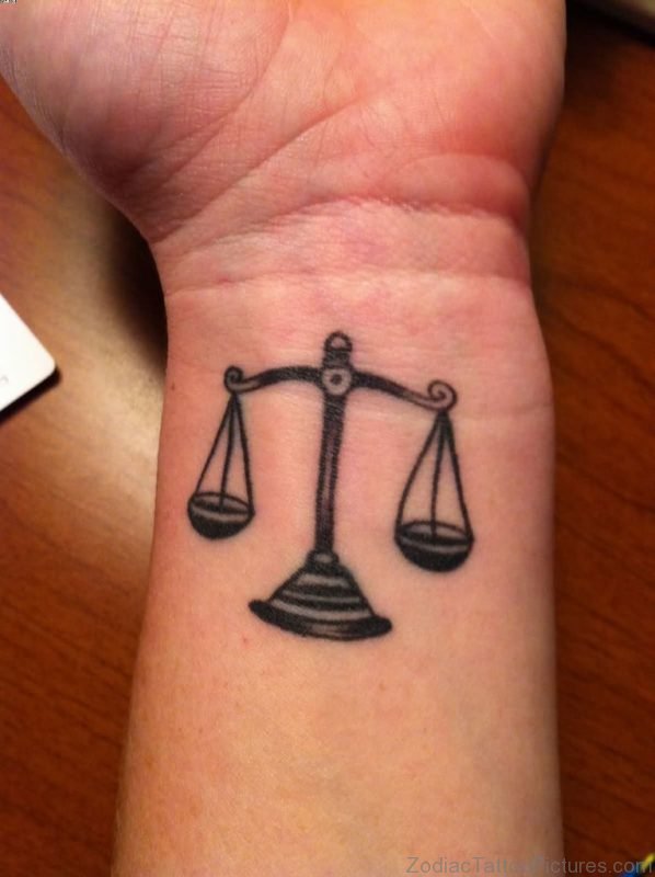 Black Ink Libra Scale Tattoo On Wrist