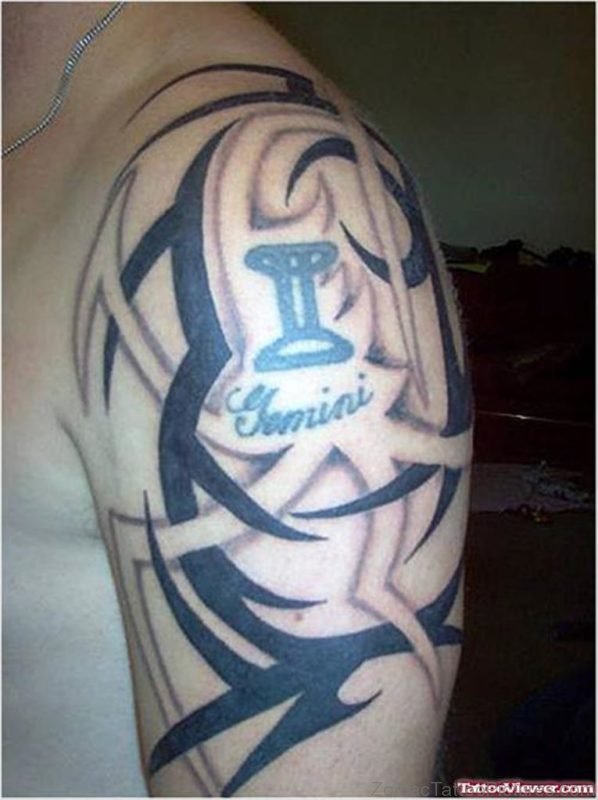 Black Ink Tribal And Gemini Tattoo On Left Shoulder