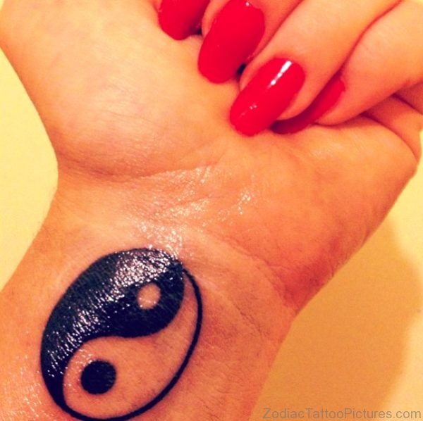 Black Yin Yang Tattoo On Girl Wrist 