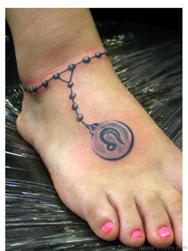 Grey Ink Leo Tattoo On Girl Right Ankle